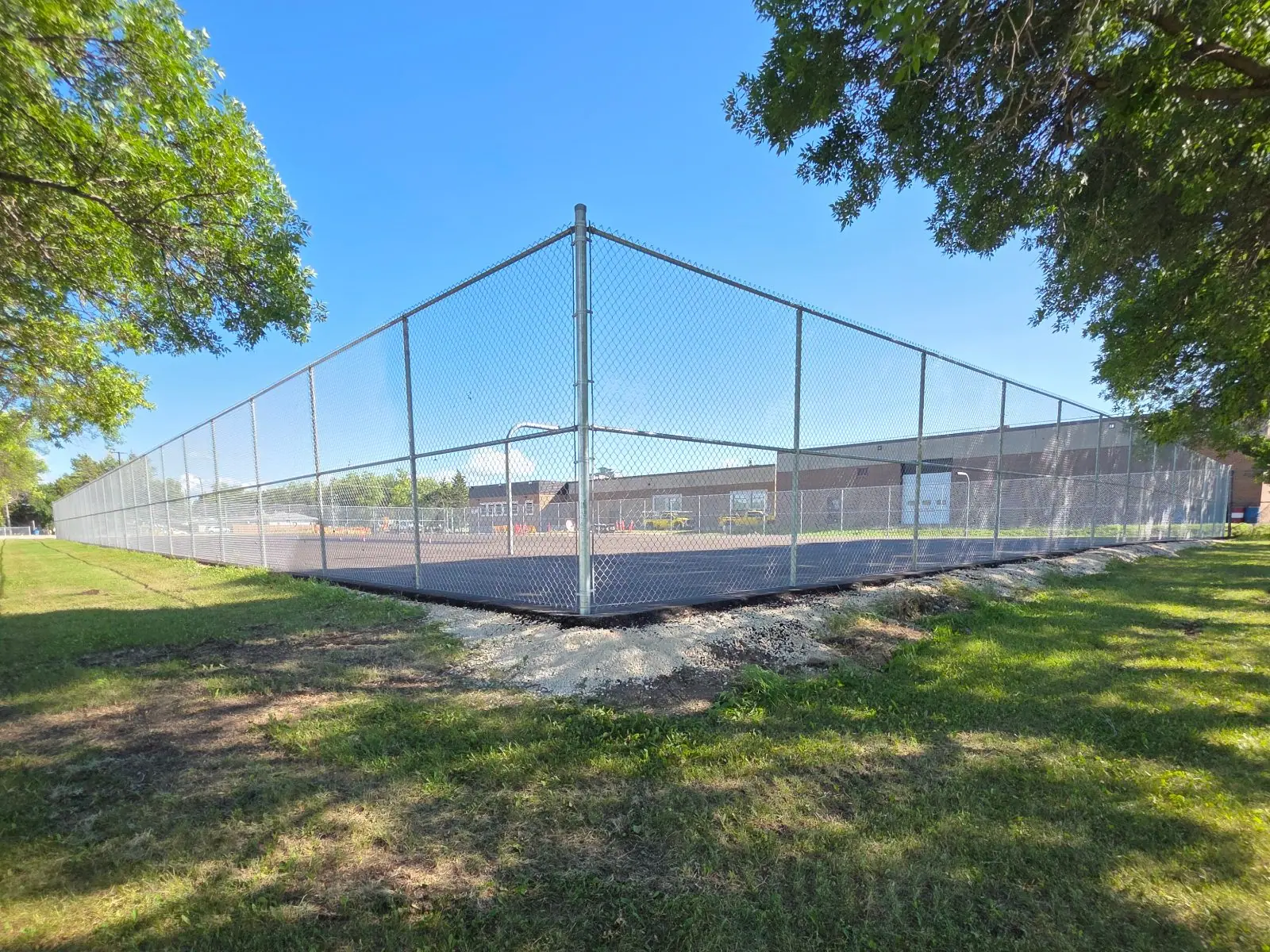 Galvanized commercial chainlink enclosure around a sports court