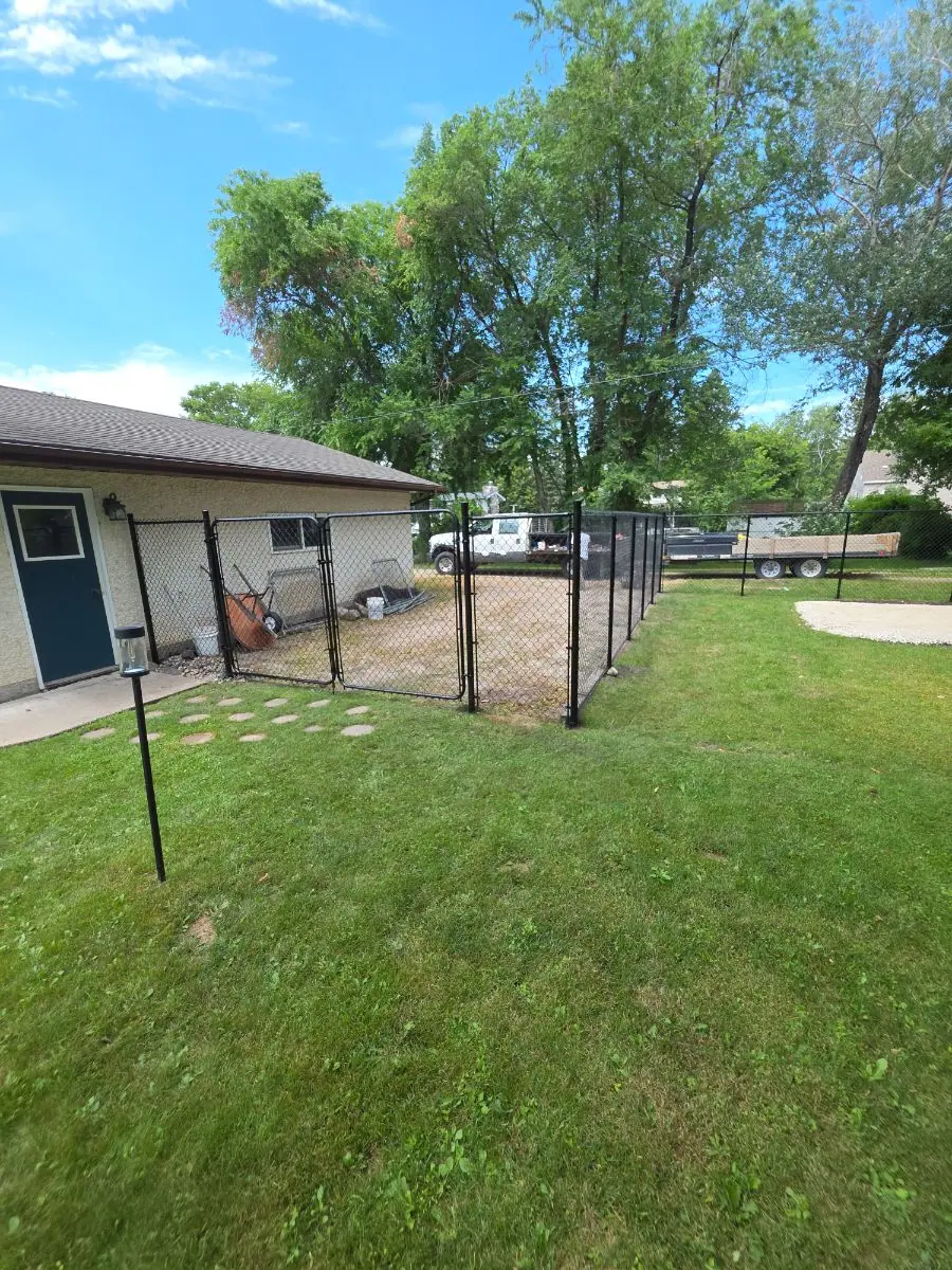 Black chainlink fence along a side yard