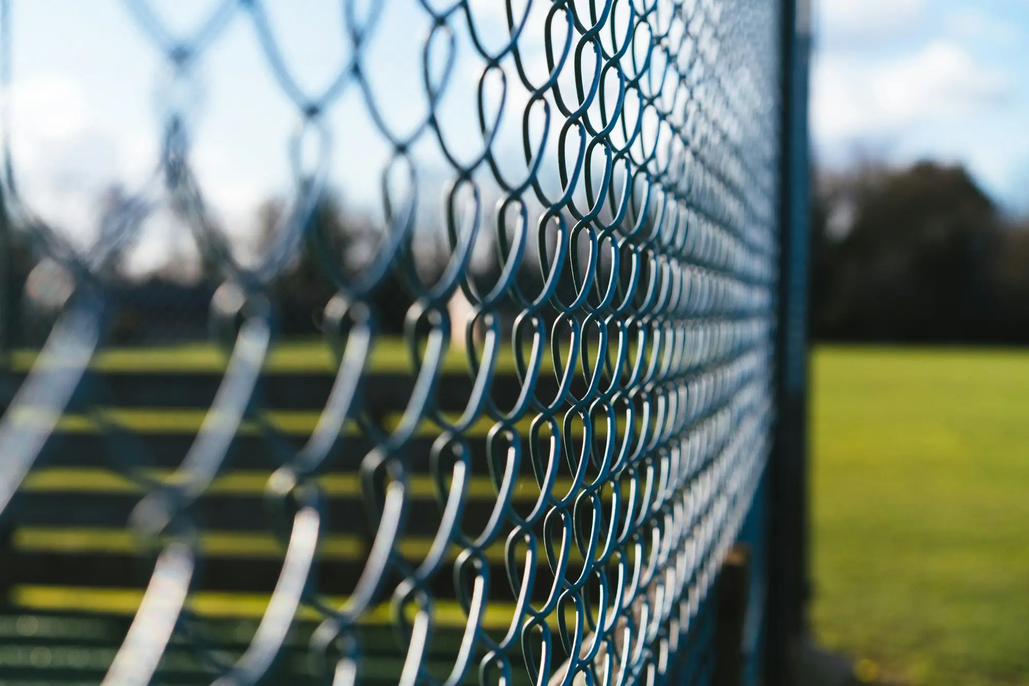 Black chainlink fence along a sports field