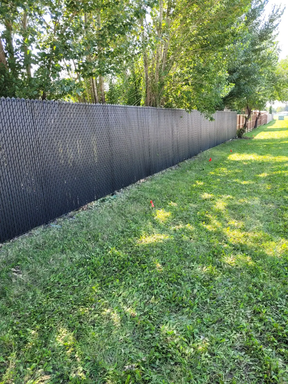 Chainlink fence with black privacy inserts