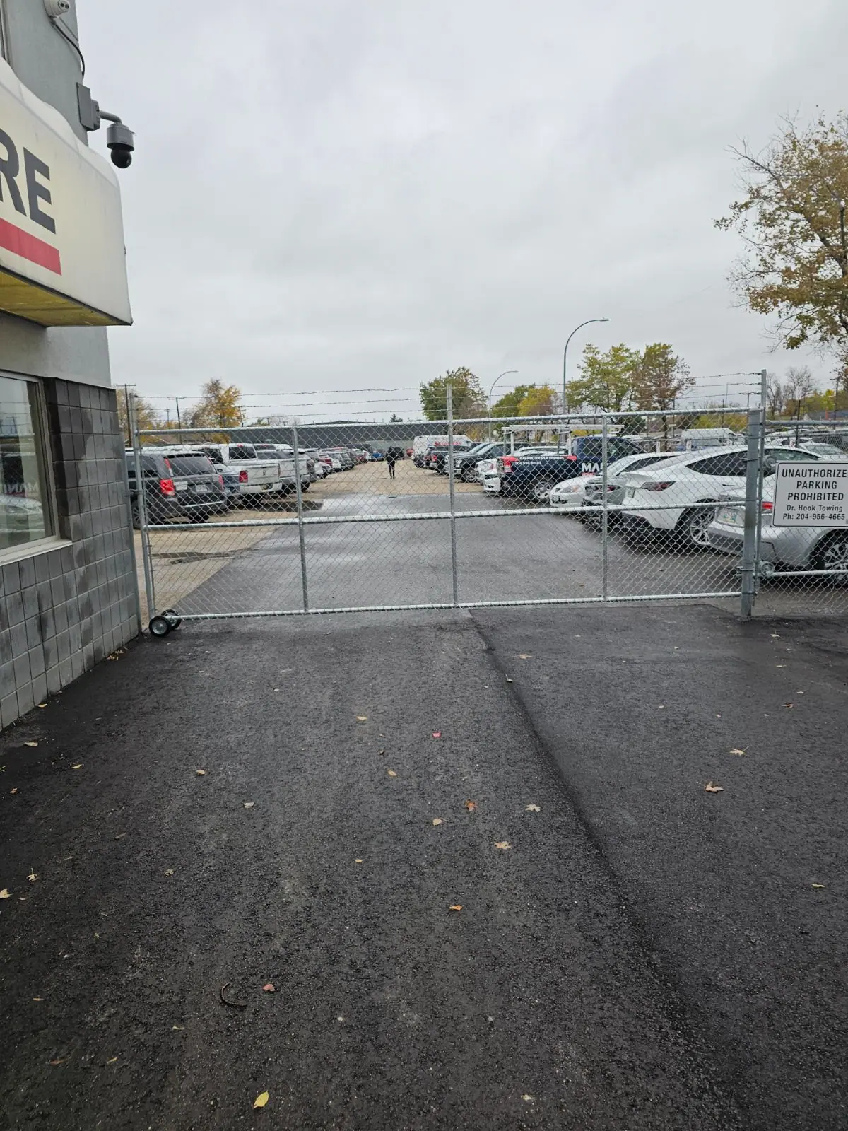 Cantilever slide gate across a lot entrance